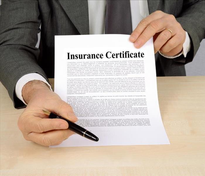 INSURANCE DOCUMENT PRESENTED FROM A SALESMAN IN A SUIT