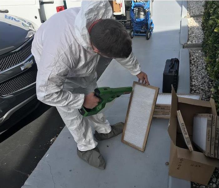 SERVPRO technician cleaning an air filter affected by mold damage