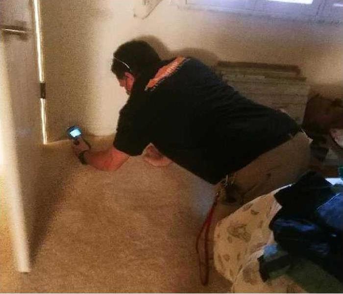 SERVPRO technician testing the moisture content of a wall